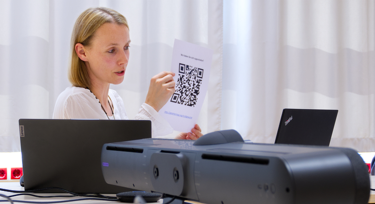 Stefanie Wagner hält im Workshop "Digitales Lernen" gedruckten QR-Code in die Kamera
